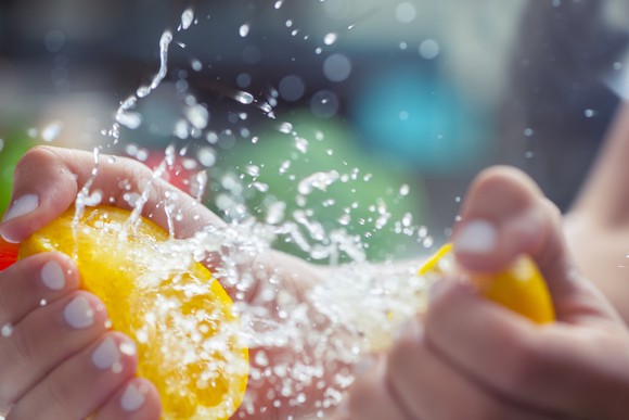 Person squeezing juice out of lemons.