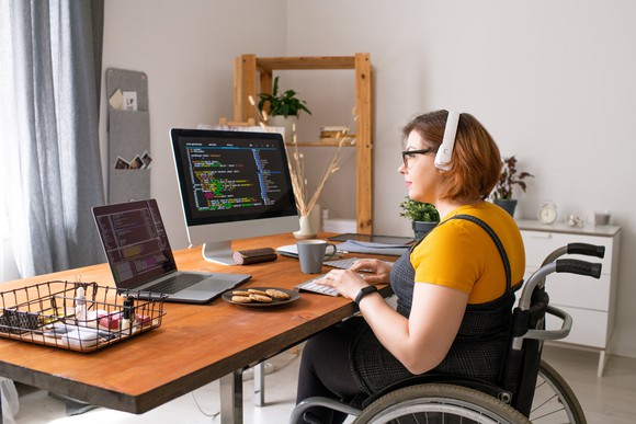 A computer programer works on a cryptocurrency code on her computer.