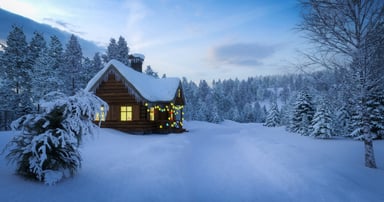 A snow-covered log cabin decorated with lights_