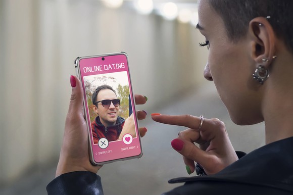 A person using a dating app on a smartphone.