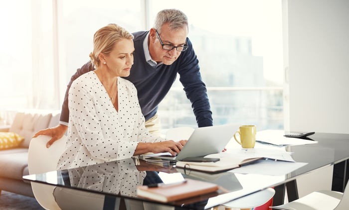 Two people at a laptop.