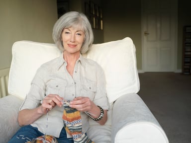 Smiling person knitting_GettyImages-74951578