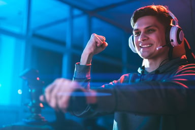 Gamer doing a fist pump while playing videogame