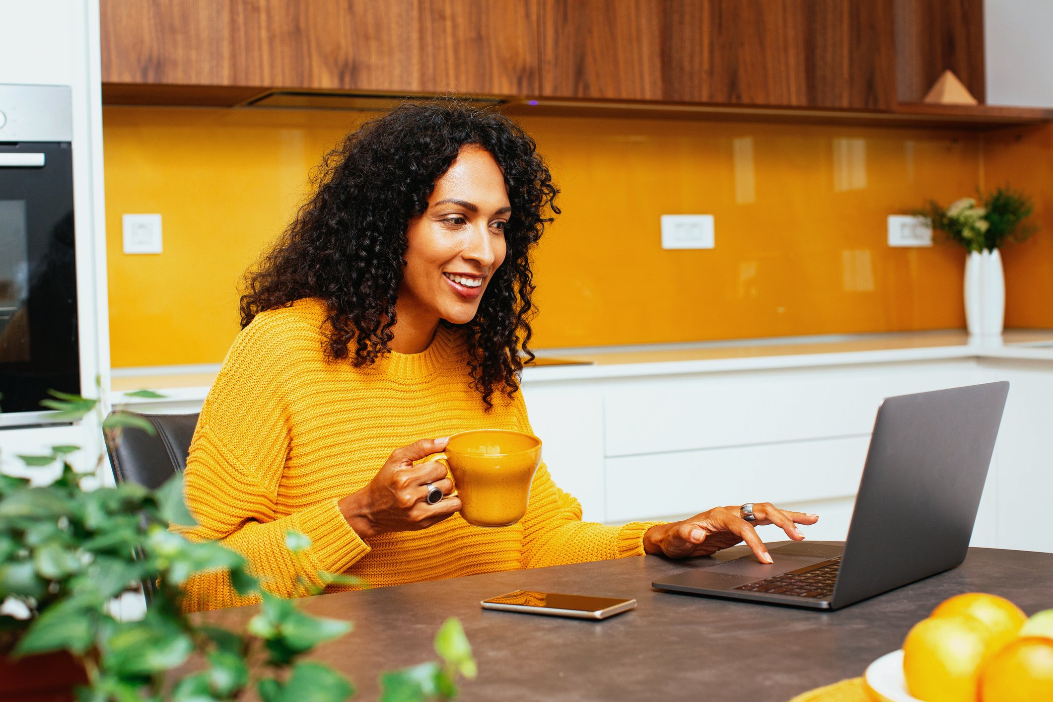 A person smiling while using a computer.