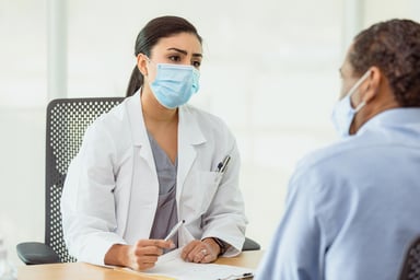 A doctor discusses with a patient