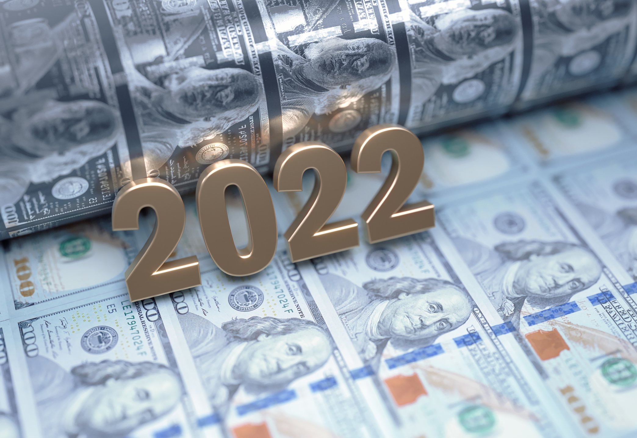 2022 on top of $100 bills coming out of a printing press..