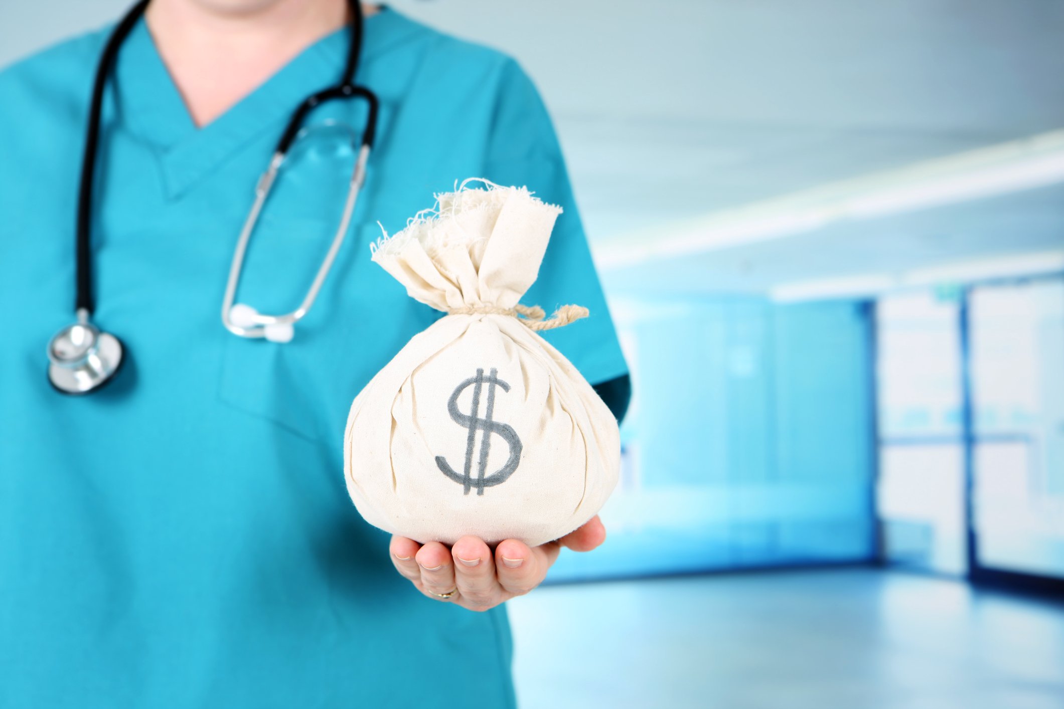 Healthcare professional holding a money bag.