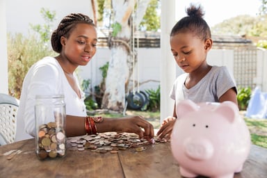 Parent counting coins with child