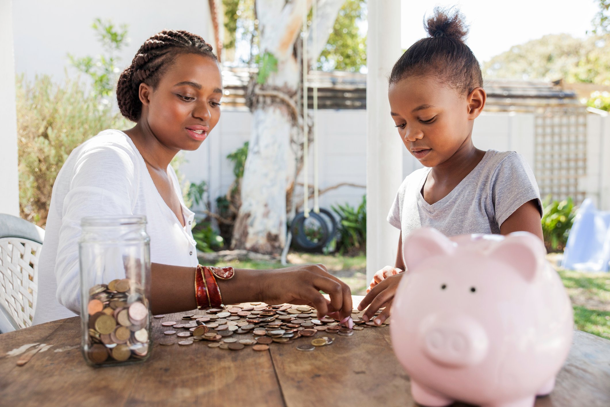 Parent counting coins with child. 