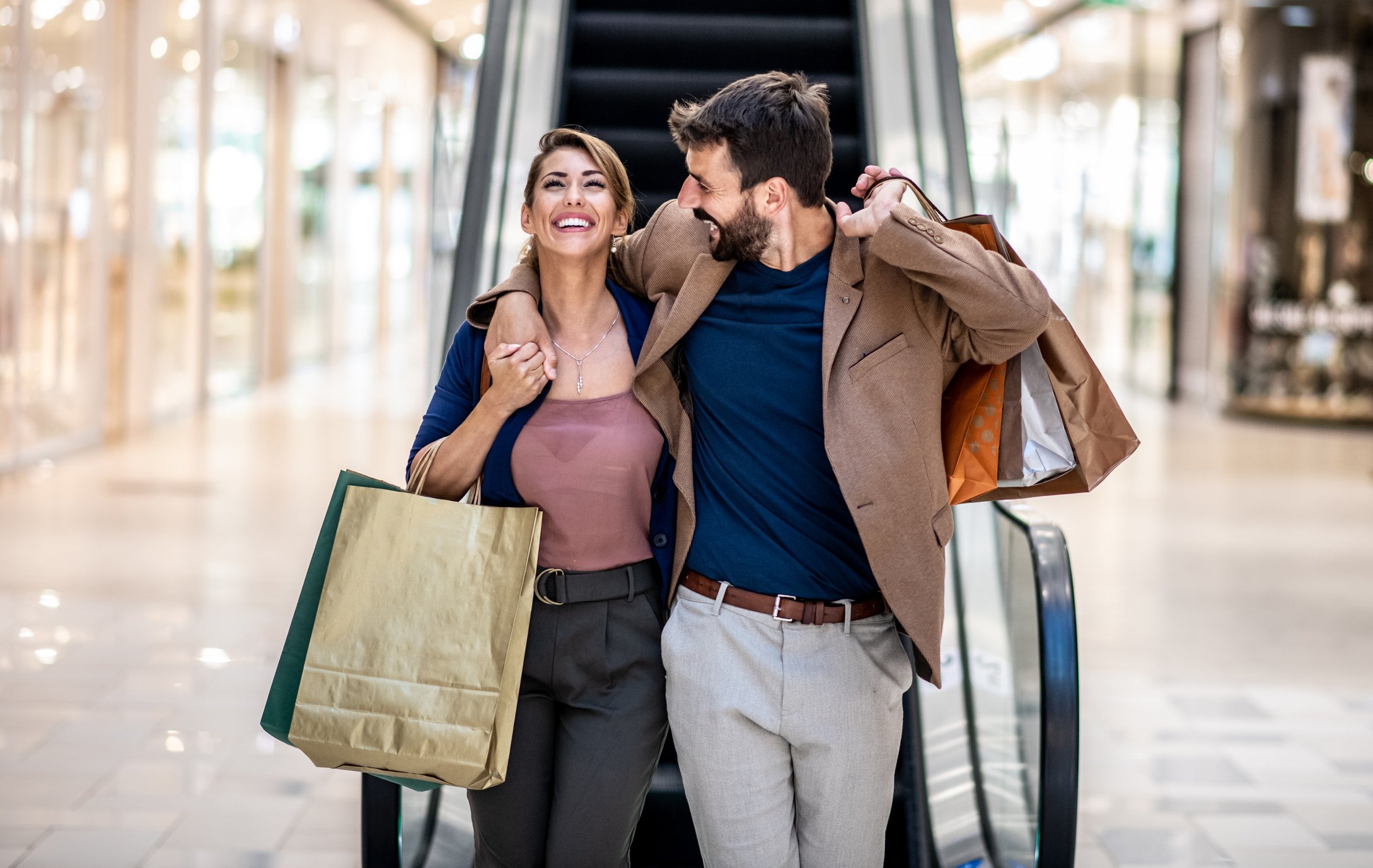 Two people shopping at a mall.