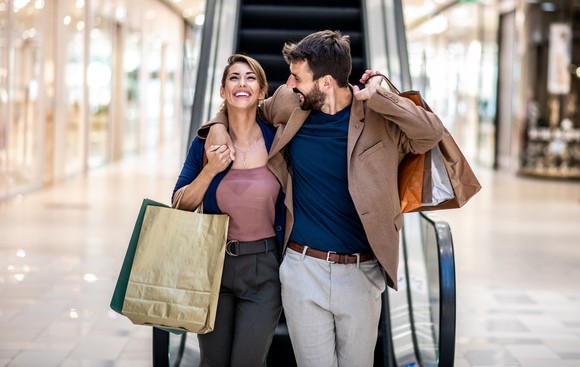 Two people shopping at a mall.