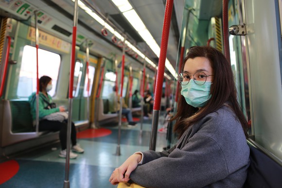 Woman wearing mask on a train.