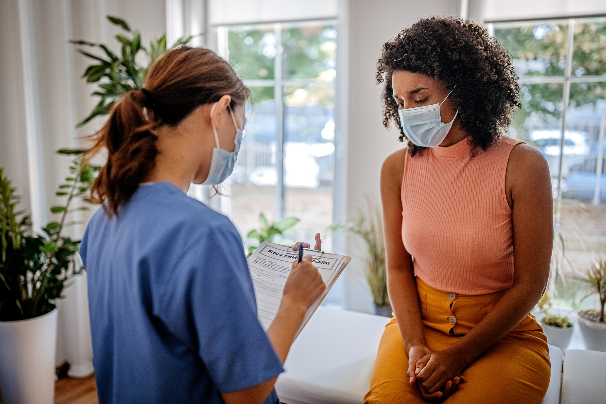 A medical professional speaks to a patient.