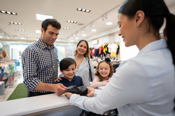 A family purchasing items at a store.