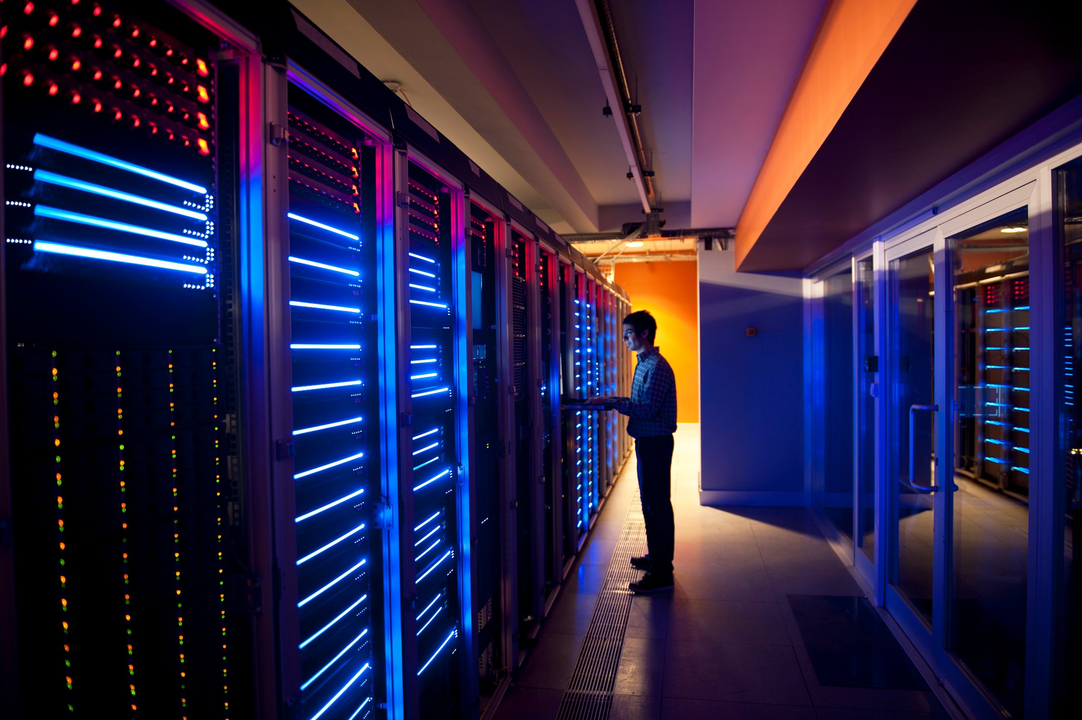 A man standing in a computer server room.