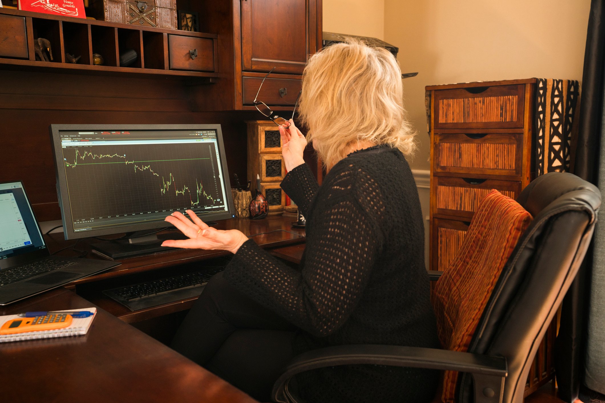 A person looking at a price chart heading down.