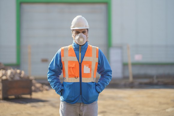 Field engineer wearing a mask at a job site.