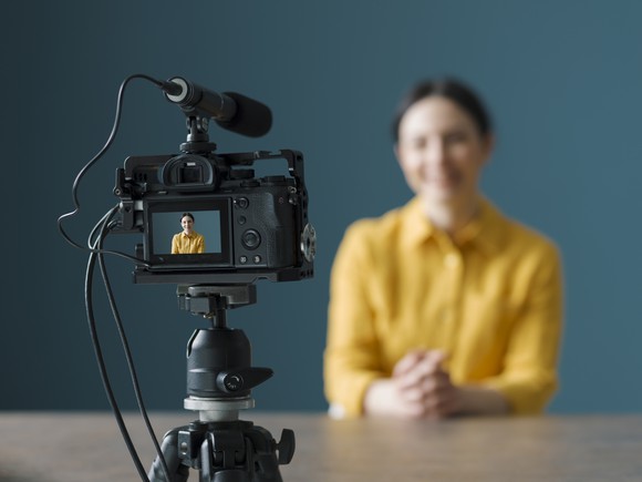 Woman sitting in front of video camera