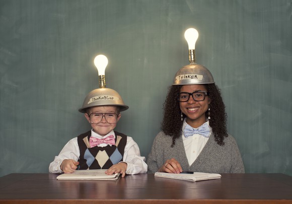 Two children with light bulbs on their heads.