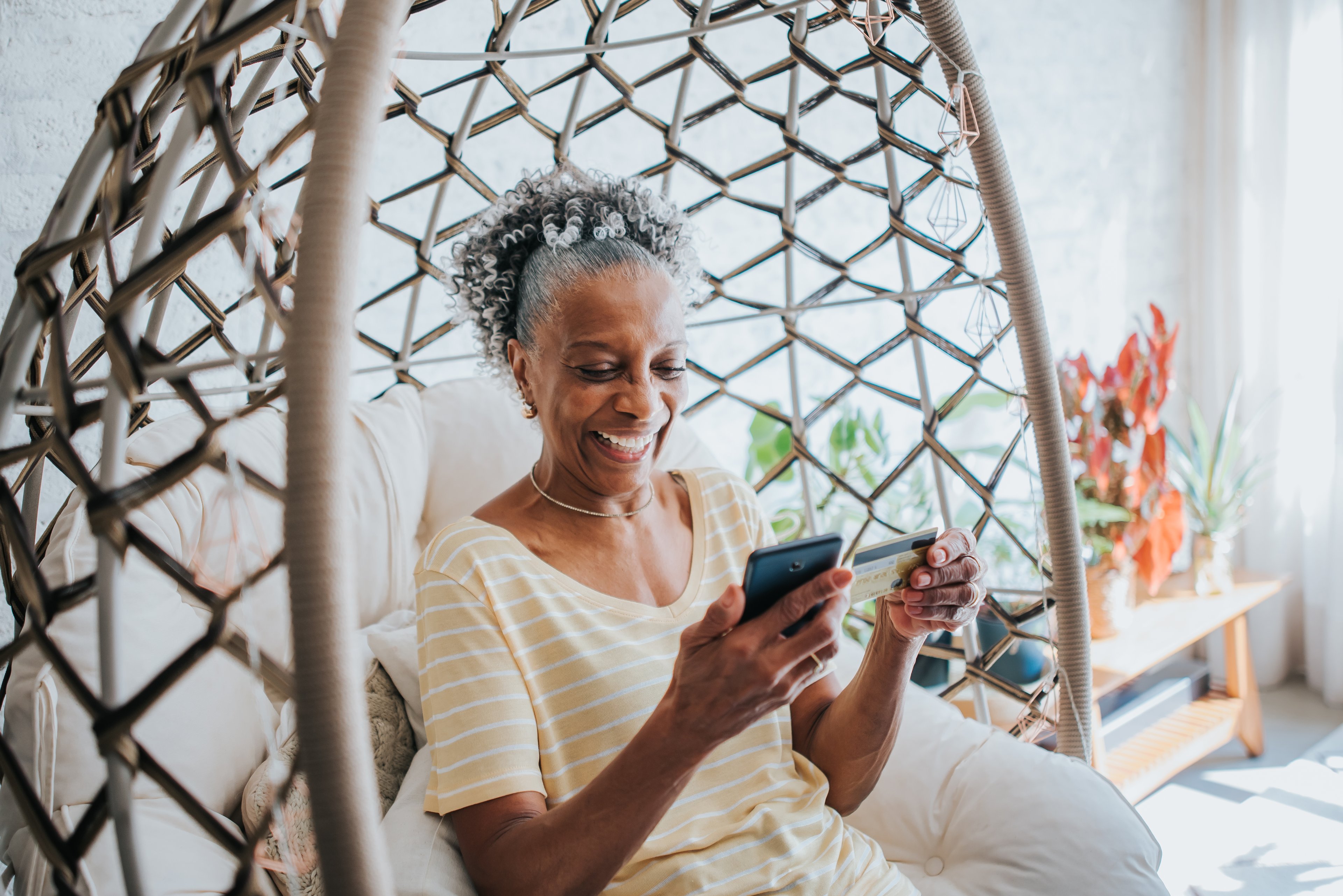 A woman pays with a credit card on her phone