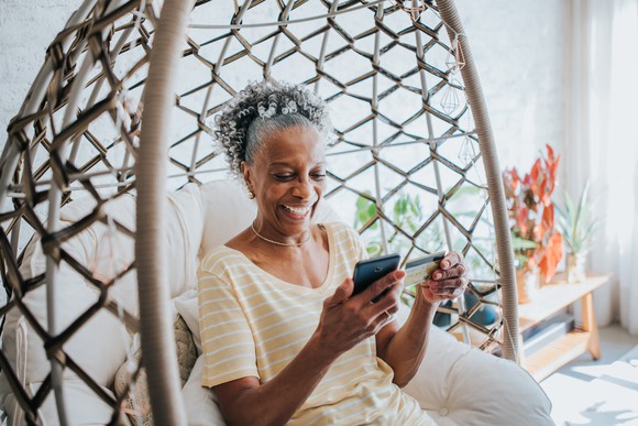 A woman pays with a credit card on her phone