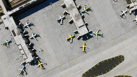 An overhead view of airplanes at an airport terminal.