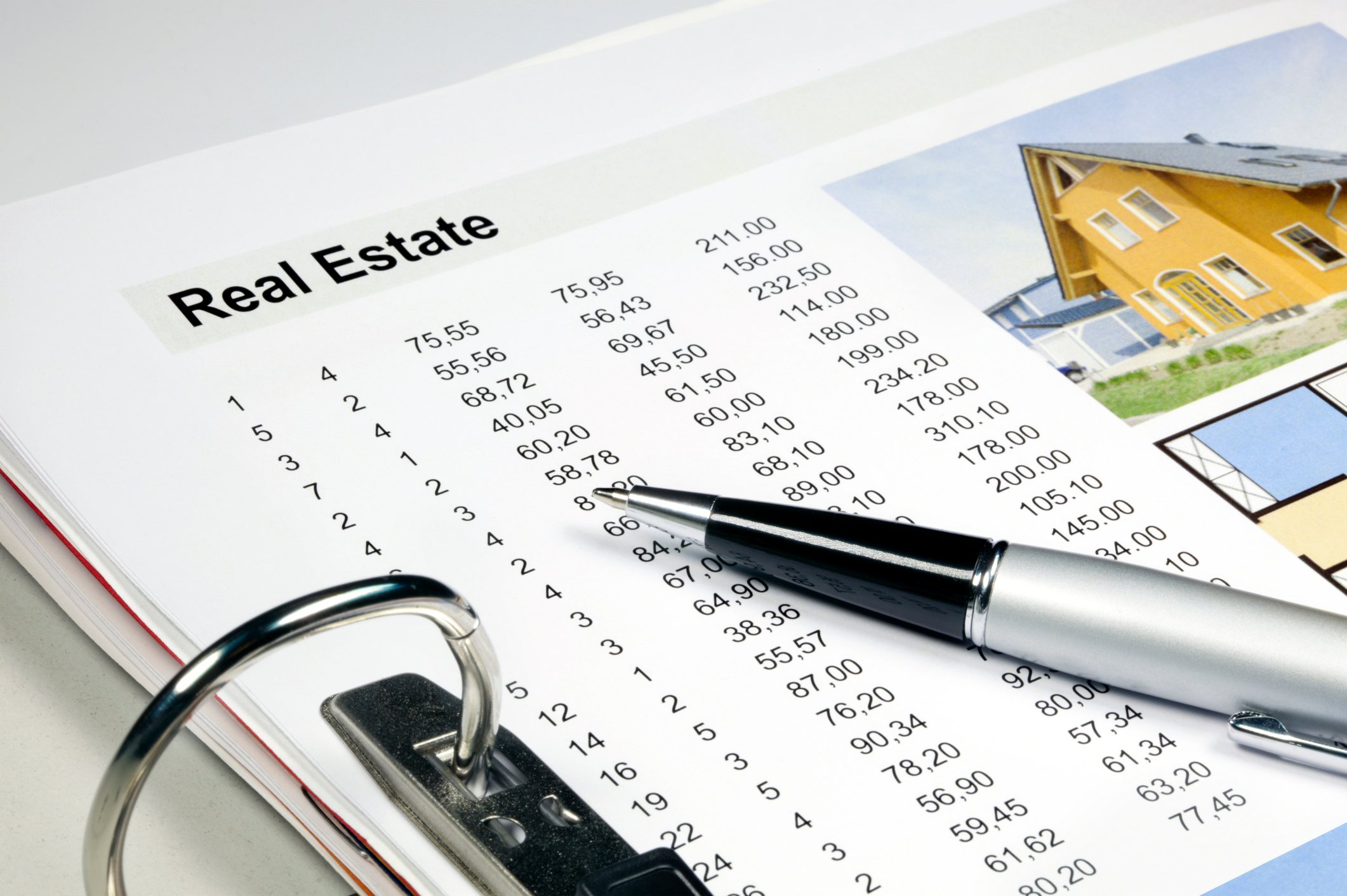 Real estate portfolio in ring binder with numbers.