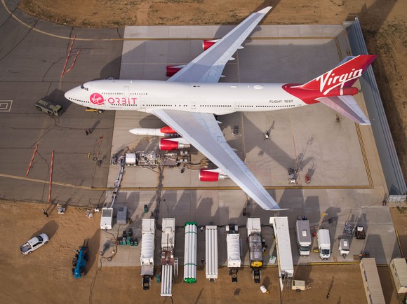 Virgin Orbit 747 sitting on tarmac with rocket ready for launch. 