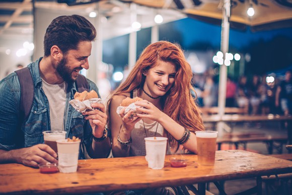 Two people eating in a burger restaurant. 