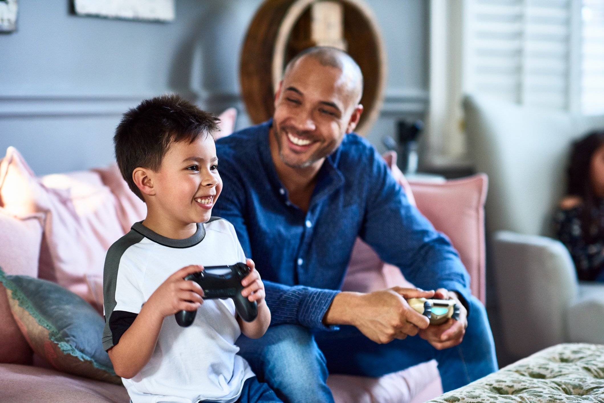 A parent and child playing a video game.