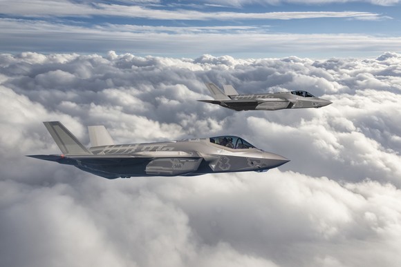 Two F-35 fighter jets in flight.