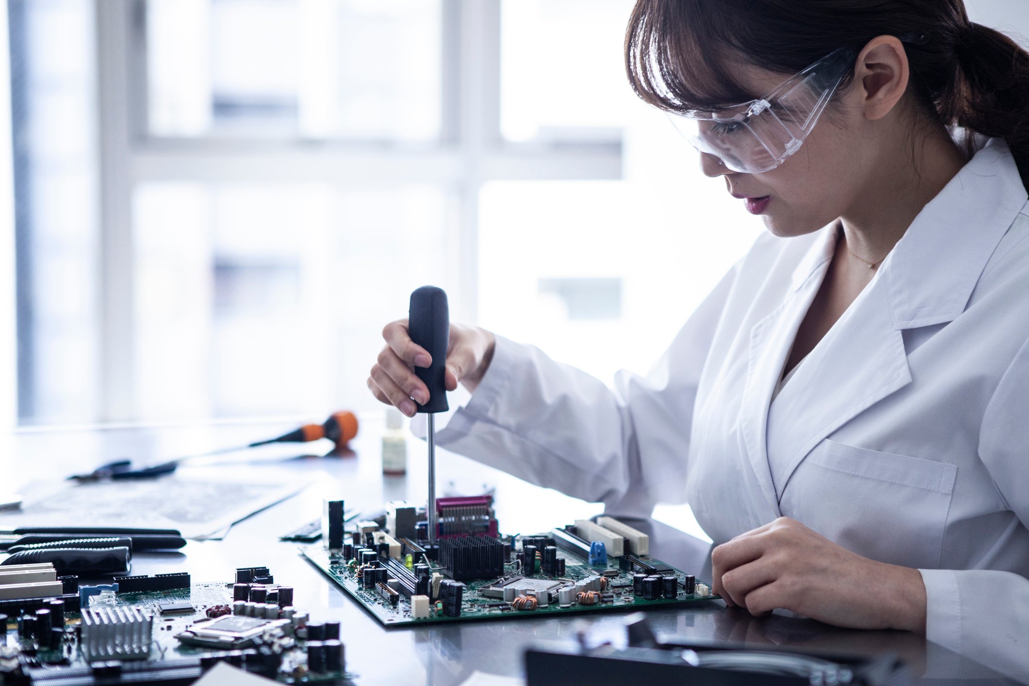Technician works on electronic equipment.