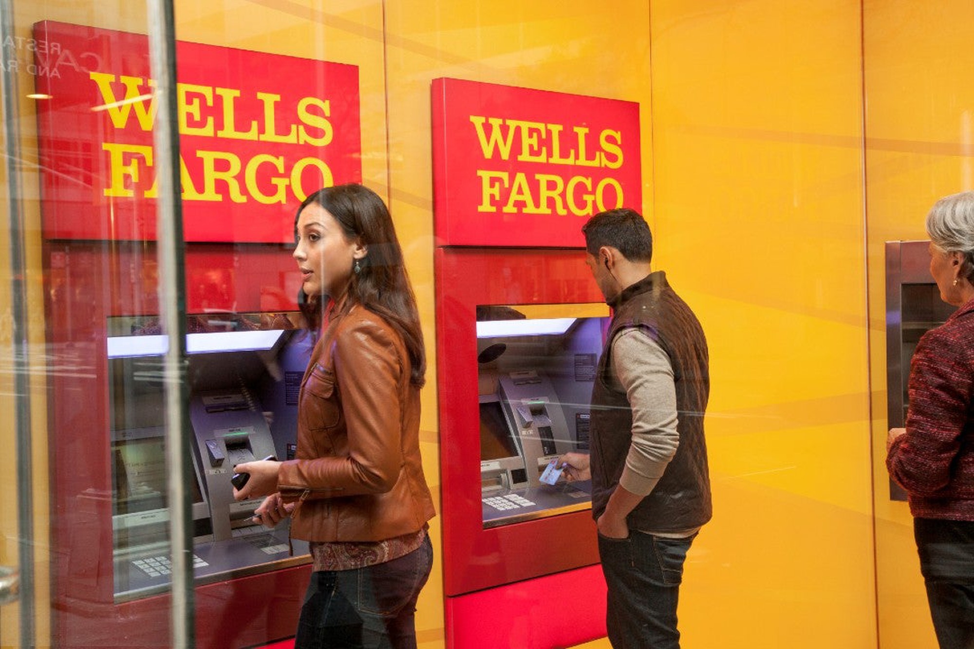 People using Wells Fargo ATMs.