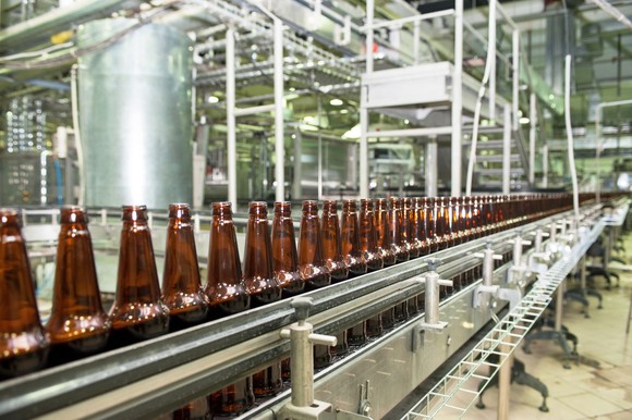 Empty bottles moving through a large bottling plant.