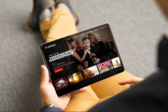 person streaming a show on tablet