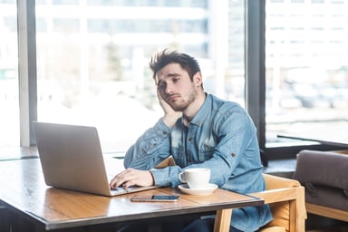 Nervous bohemian with laptop in cafe