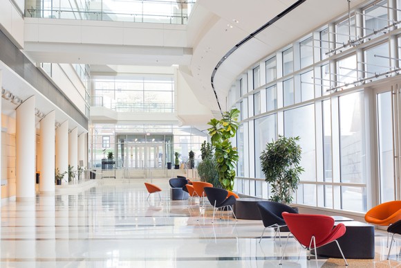 Office lobby interior with chairs in front of windows.