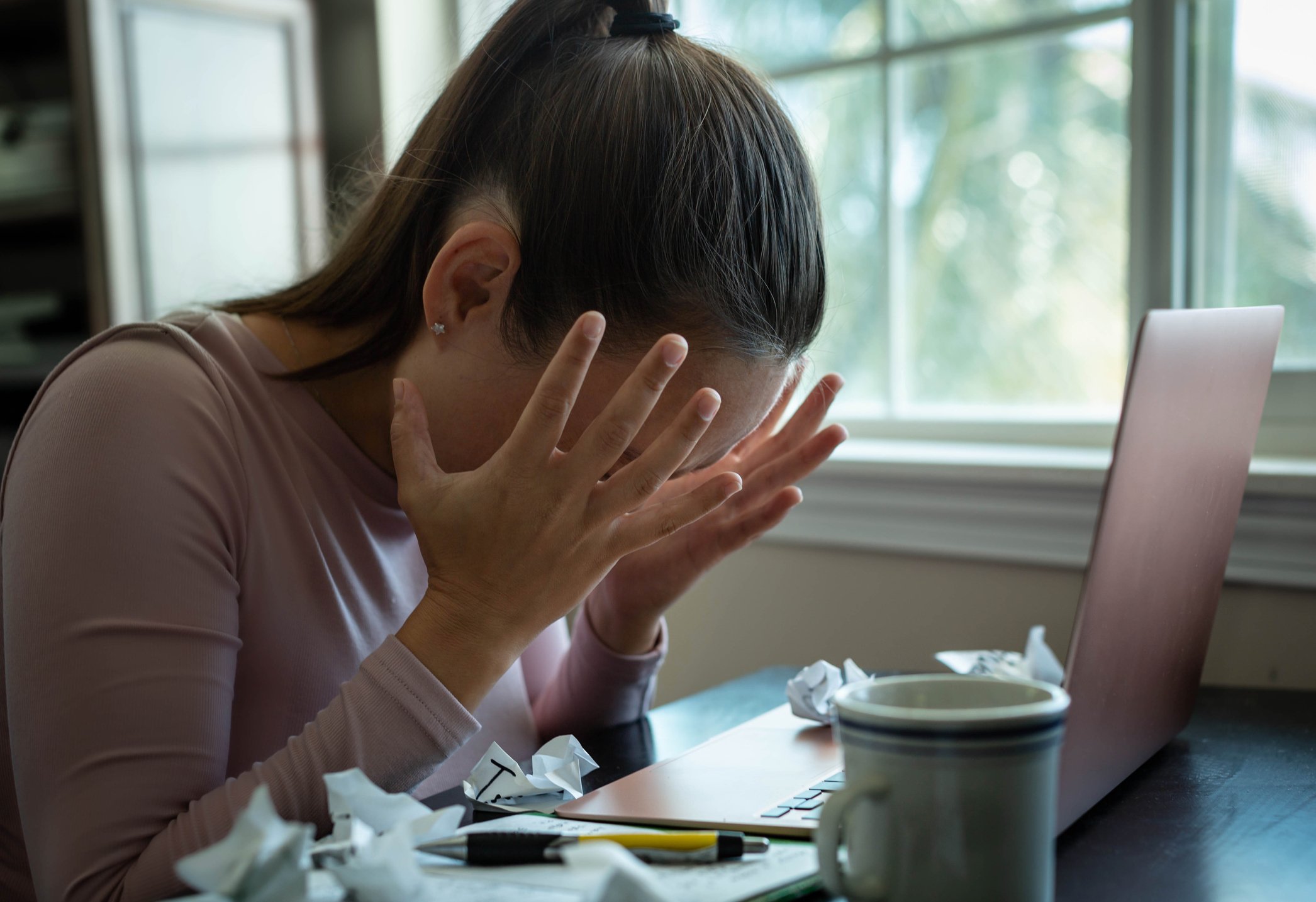 Person at their computer and frustrated.