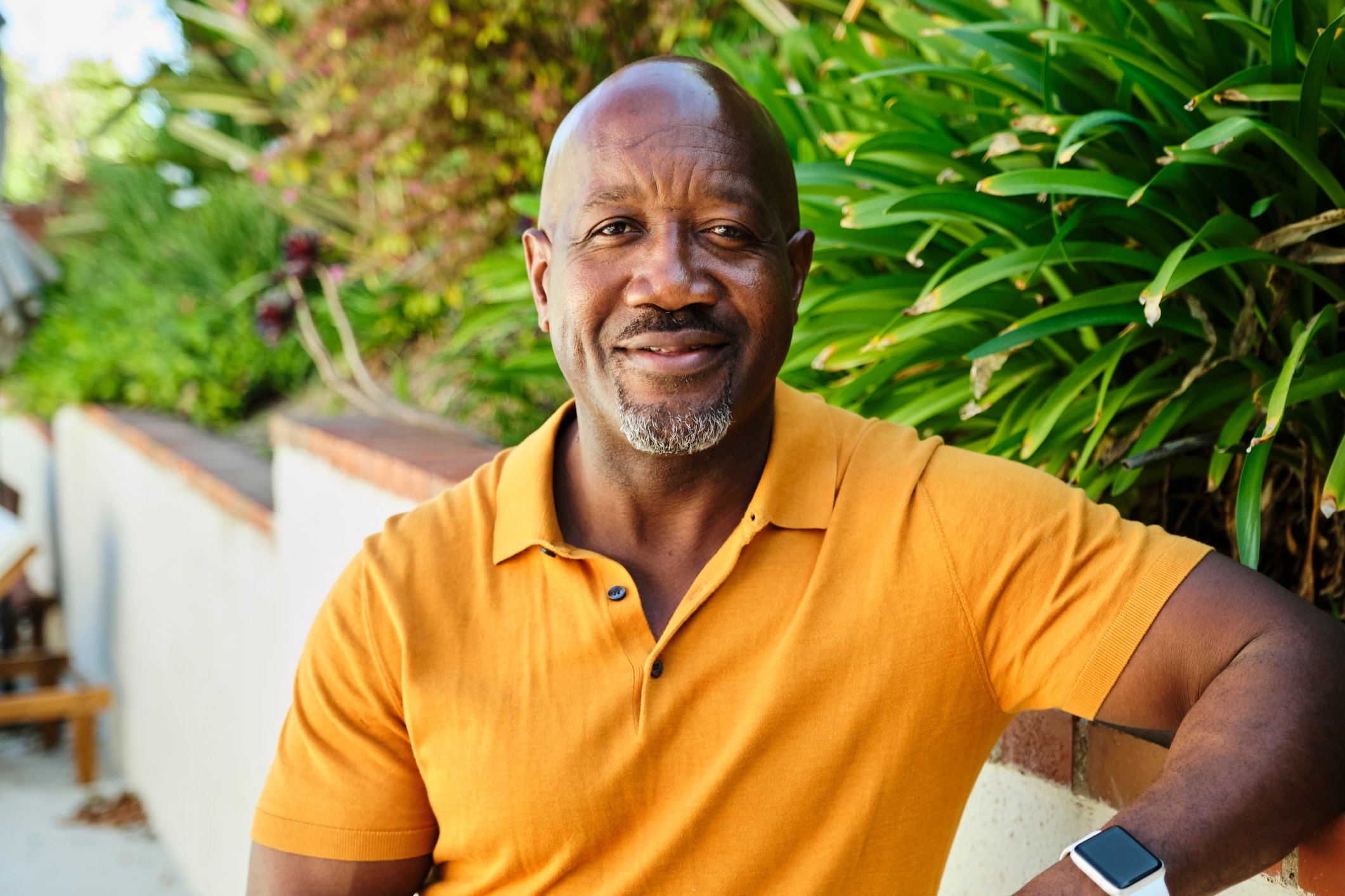 A smiling person outdoors.