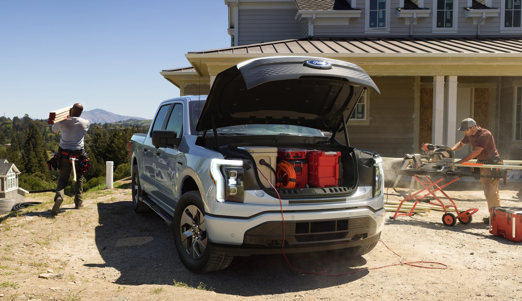 A 2022 Ford F-150 Lightning Pro, an electric pickup, on a construction site.