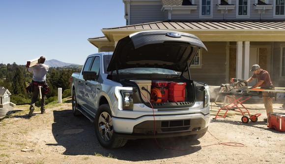 A 2022 Ford F-150 Lightning Pro, an electric pickup, on a construction site.