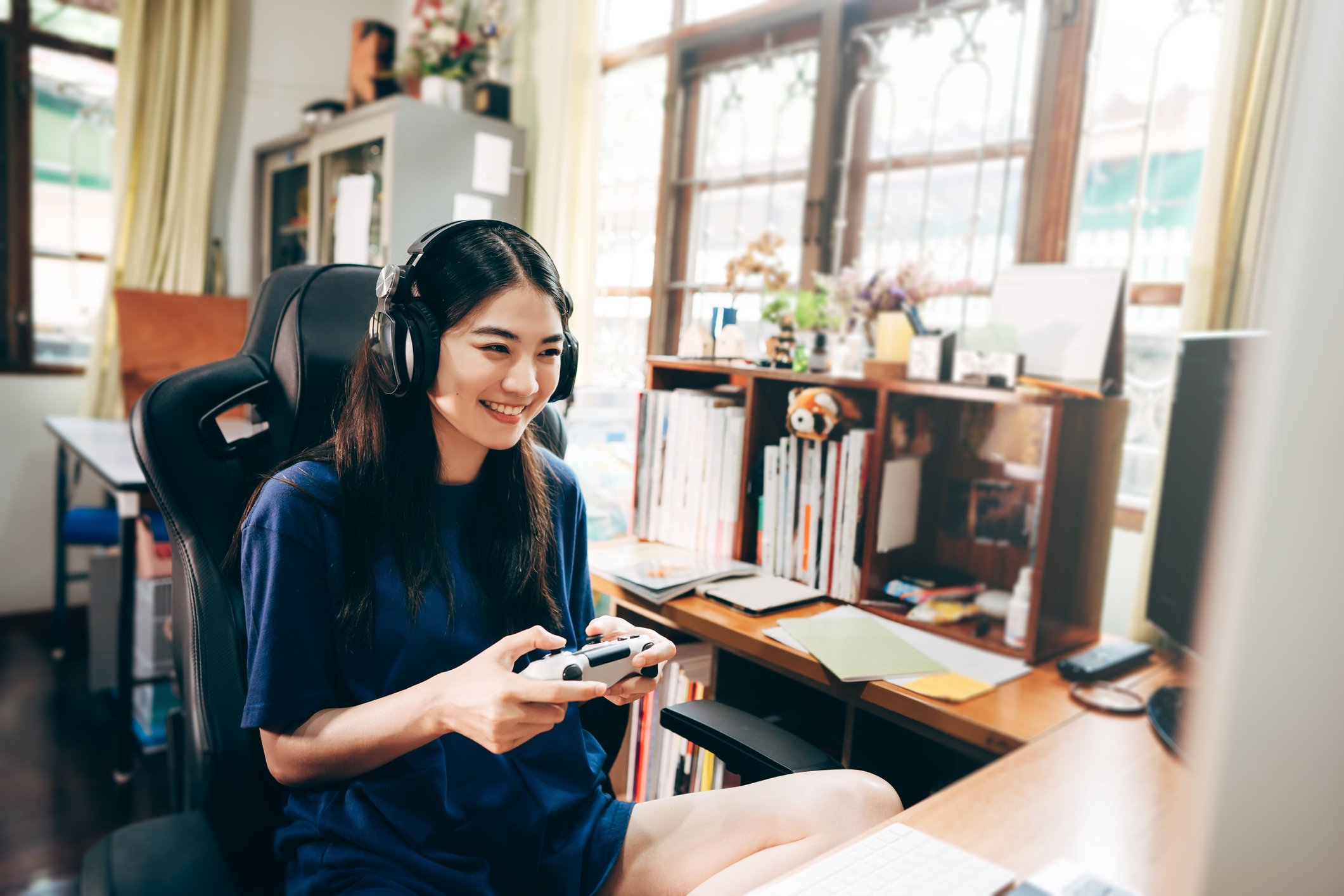 A gamer wearing a headset while playing a video game.