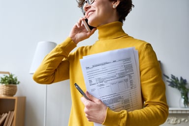 A person holding tax forms_GettyImages-1131867646