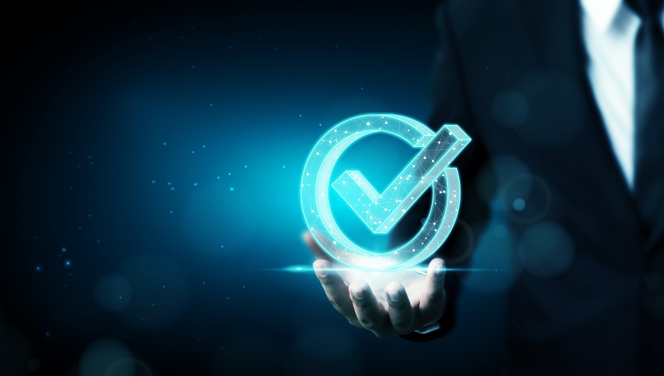 Person holding out hand with digital check mark resting on it.