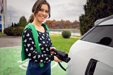 A person charging an electric car.