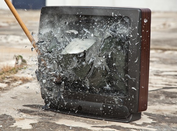 A sledgehammer smashing a television.