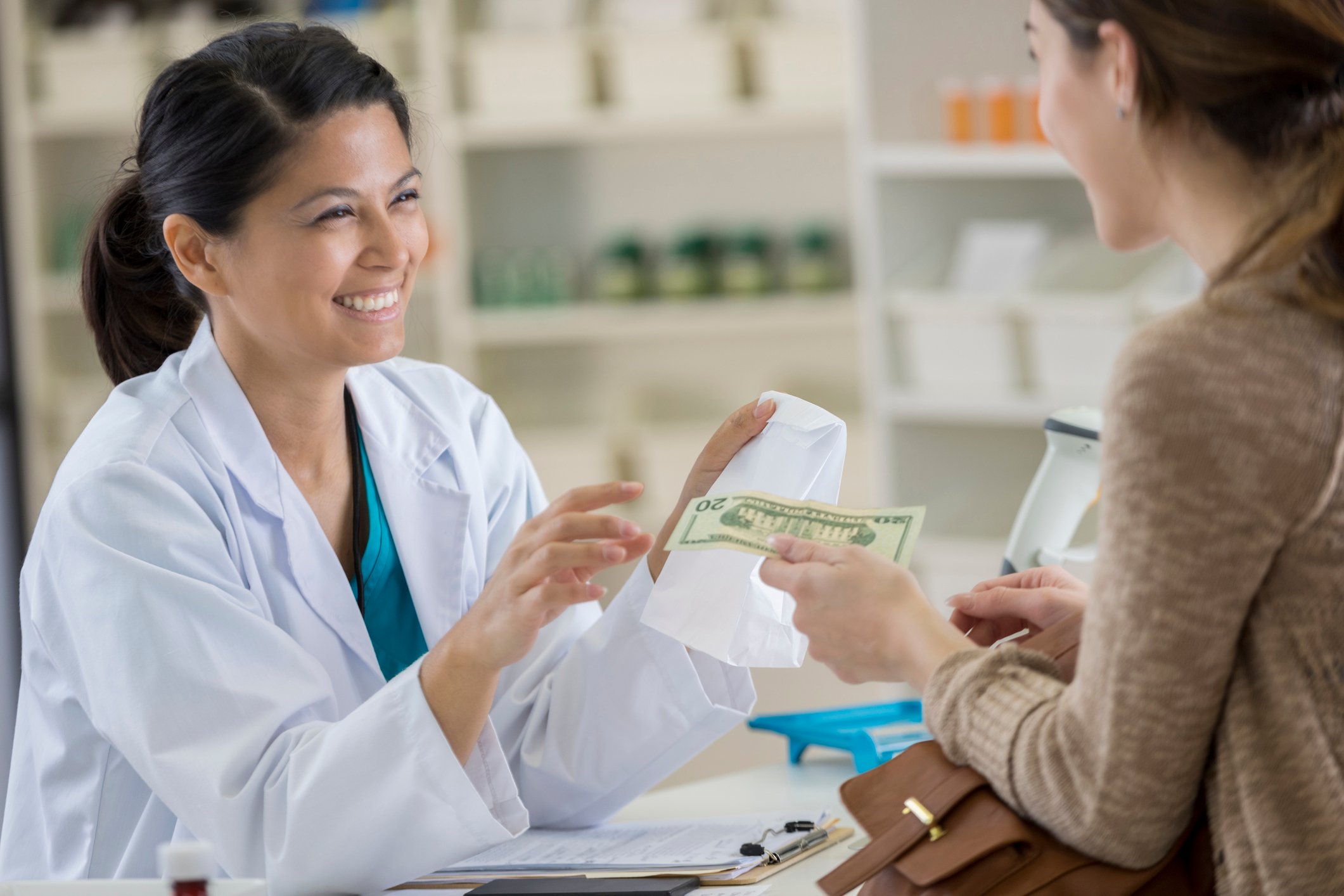 Patient paying for medicines at a pharmacy. 