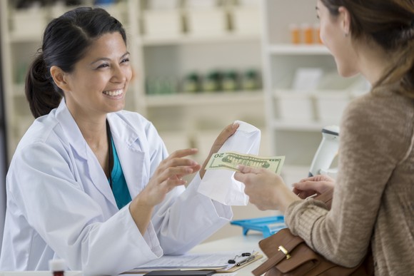 Patient paying for medicines at a pharmacy. 
