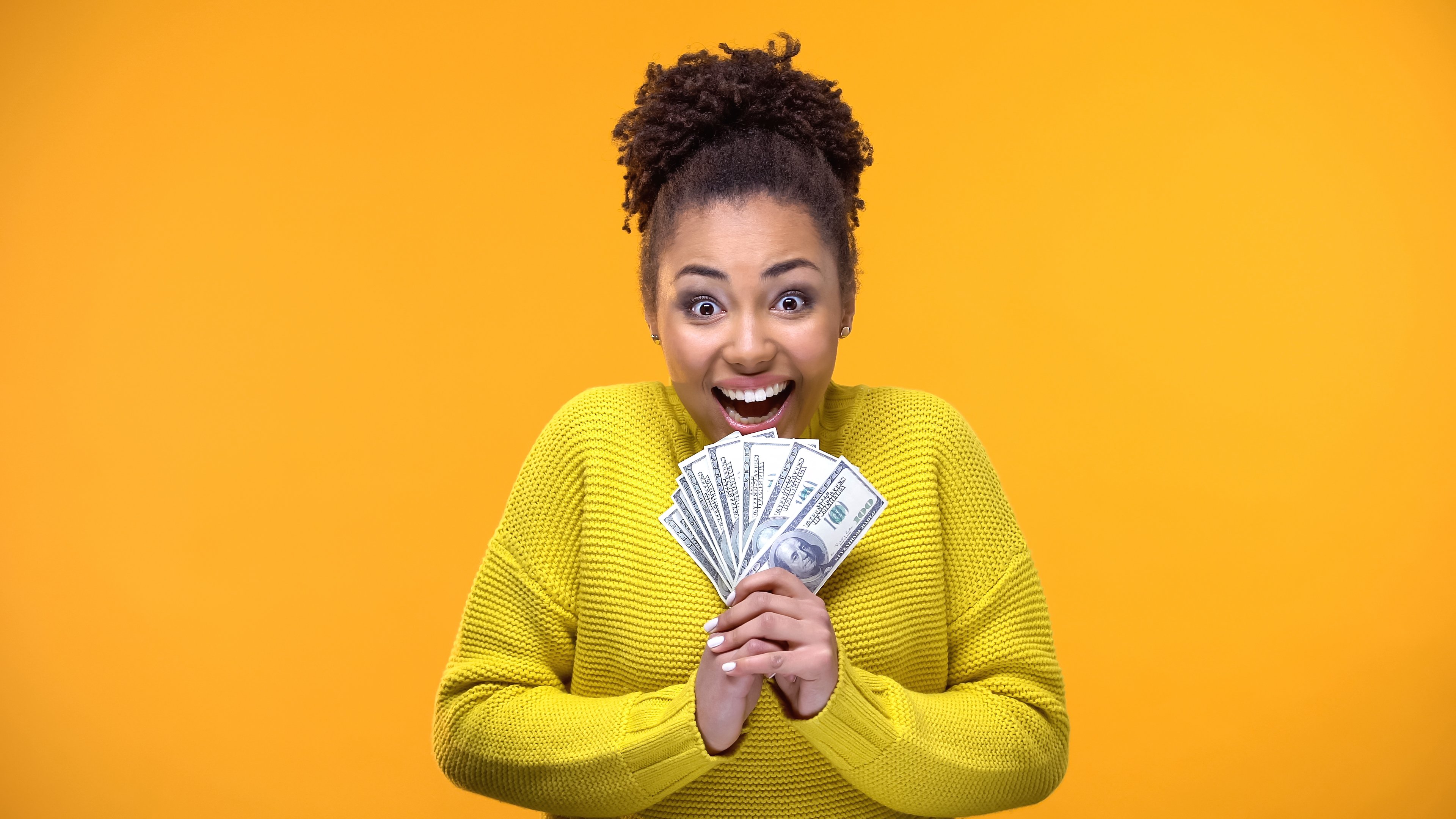 Young Woman holding Cash -- GettyImages-1142207897