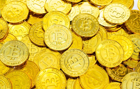 A pile of gold bitcoins.